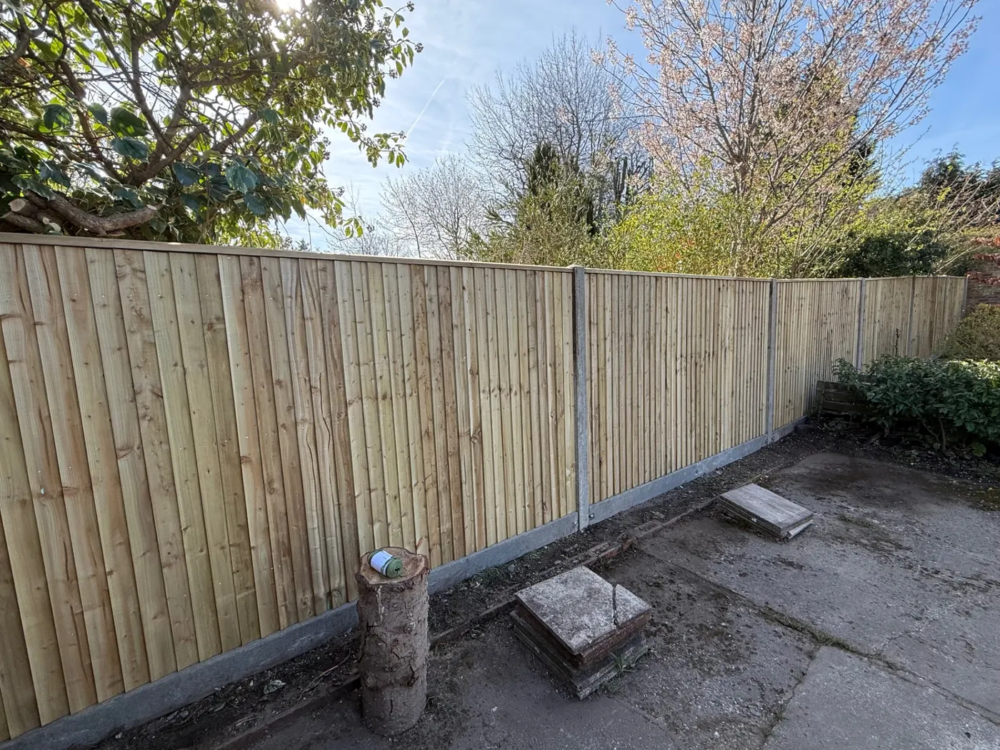 Closeboard fence with concrete posts and gravel boards in a back garden